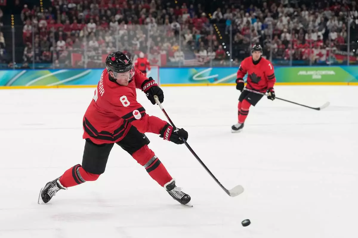 Canada's Cale Makar (8) scores during a men's ice hockey gold medal game between Canada and the United States at the 2026 Winter Olympics, in Milan, Italy, Sunday, Feb. 22, 2026. (AP Photo/Hassan Ammar)