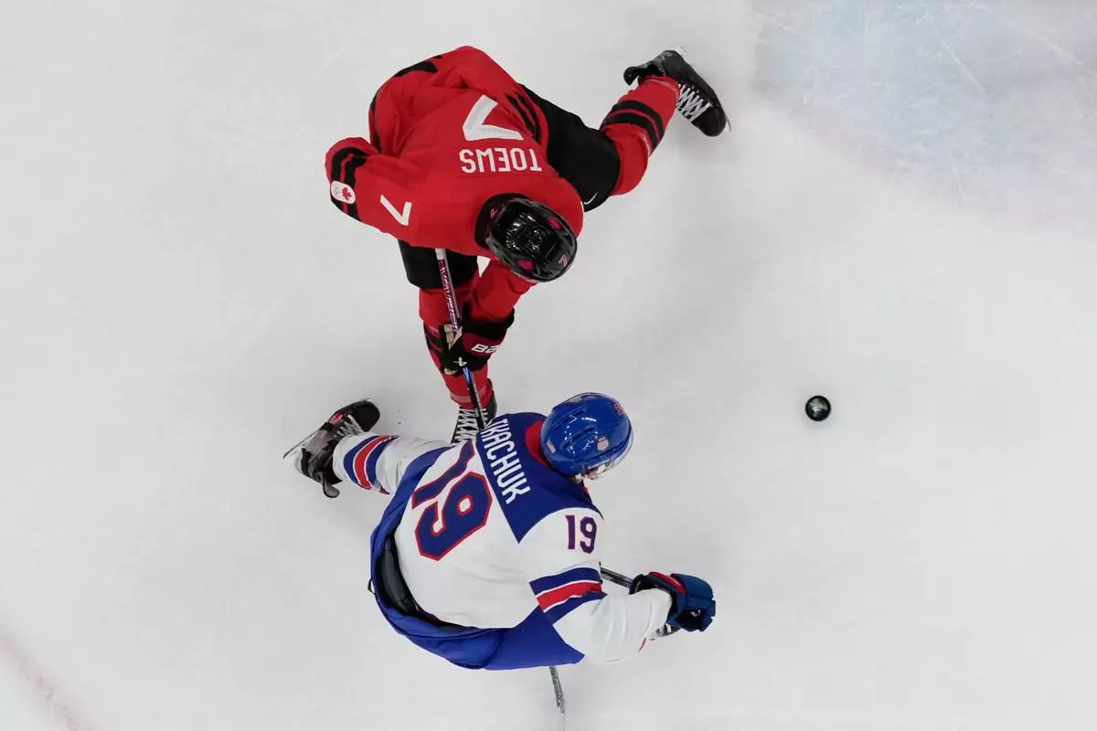 United States' Matthew Tkachuk (19) challenges with Canada's Devon Toews (7) during a men's ice hockey gold medal game between Canada and the United States at the 2026 Winter Olympics, in Milan, Italy, Sunday, Feb. 22, 2026. (AP Photo/Nikos Seimenakis)
