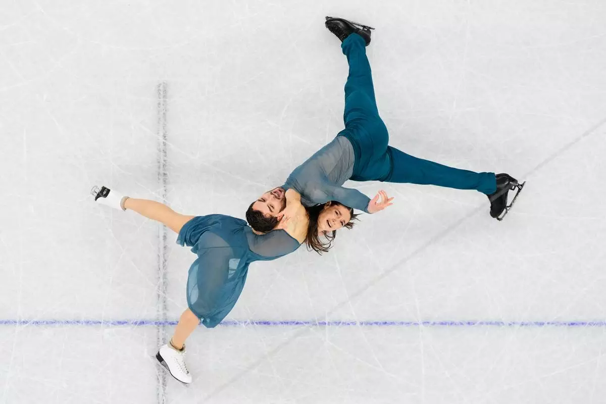 Laurence Fournier Beaudry and Guillaume Cizeron of France compete during the ice dancing free skate in figure skating at the 2026 Winter Olympics, in Milan, Italy, Wednesday, Feb. 11, 2026. (AP Photo/Bernat Armangue)