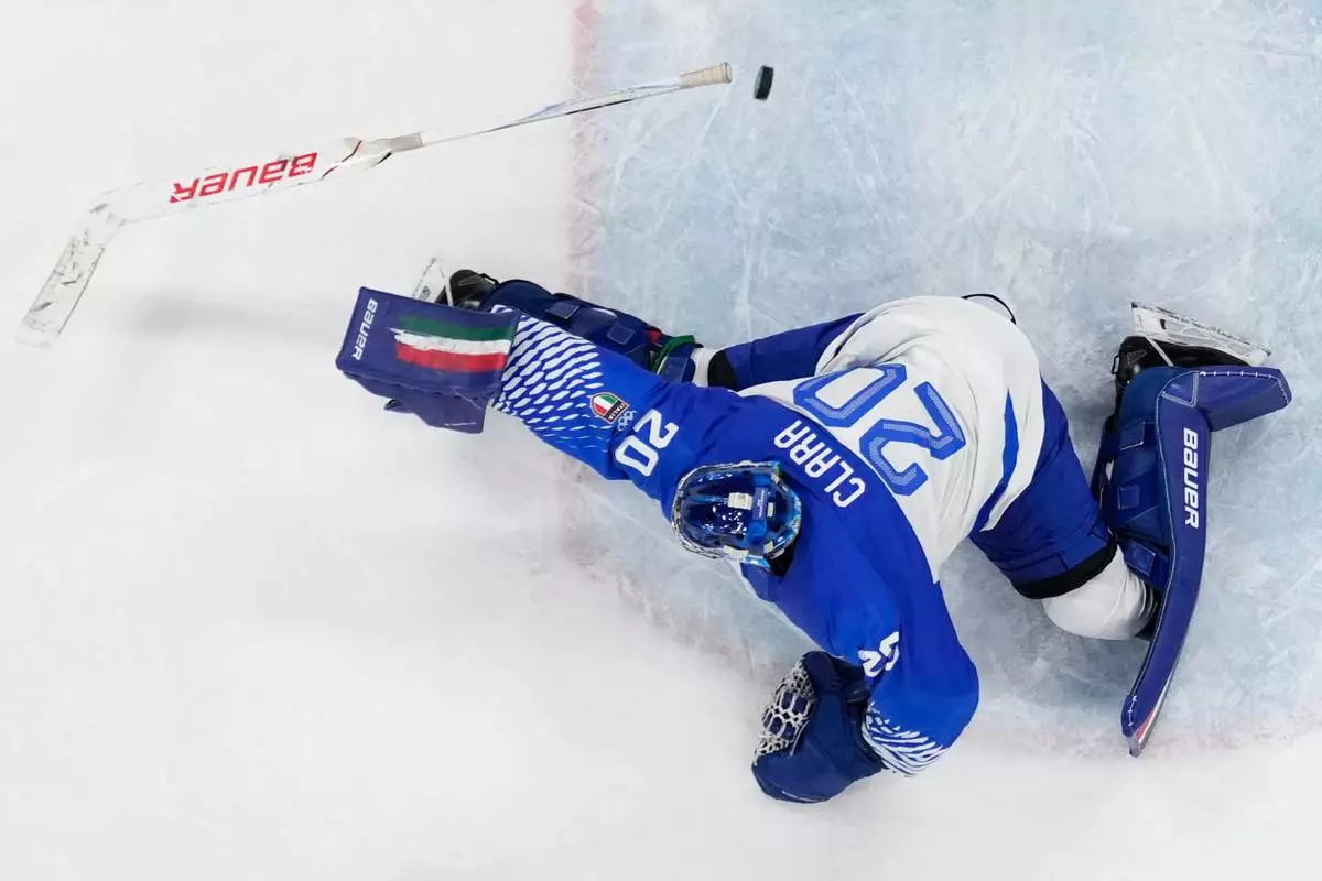 Italy's goalkeeper Damian Clara fails to make a save during a preliminary round game of men's ice hockey between Finland and Italy at the 2026 Winter Olympics, in Milan, Italy, Saturday, Feb. 14, 2026. (AP Photo/Petr David Josek)