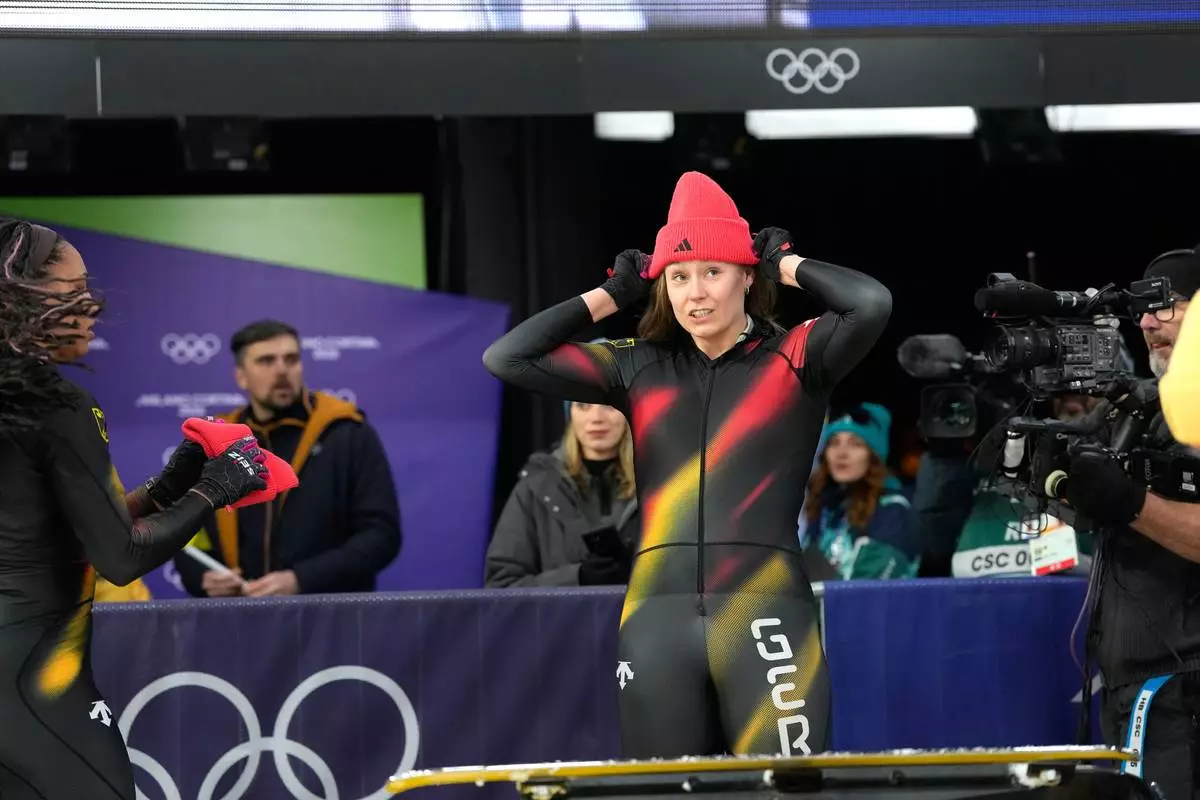 Germany's Laura Nolte reacts as she arrives at the finish during a two women bobsled run at the 2026 Winter Olympics, in Cortina d'Ampezzo, Italy, Friday, Feb. 20, 2026. (AP Photo/Alessandra Tarantino)