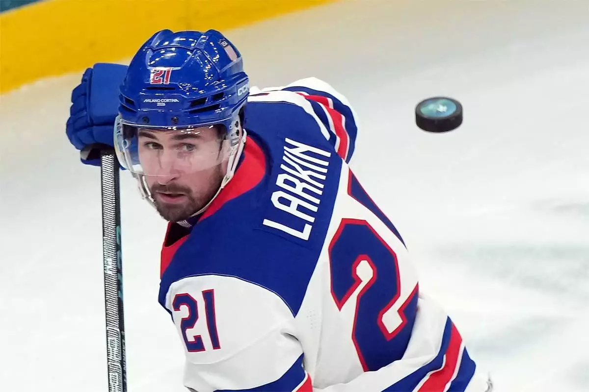 United States' Dylan Larkin (21) watches as his shot is blocked by Slovakia goalkeeper Samuel Hlavaj during the first period of a men's ice hockey semifinal game at the 2026 Winter Olympics in Milan, Italy, Friday, Feb. 20, 2026. (AP Photo/Carolyn Kaster)