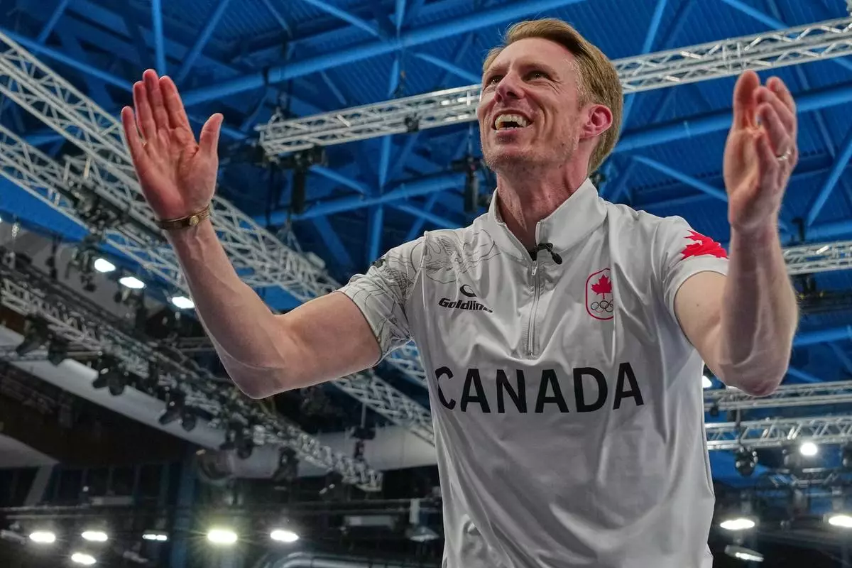 Canada's Marc Kennedy celebrates defeating Britain in a men's curling gold medal match, at the 2026 Winter Olympics, in Cortina d'Ampezzo, Italy, Saturday, Feb. 21, 2026. (AP Photo/Misper Apawu)