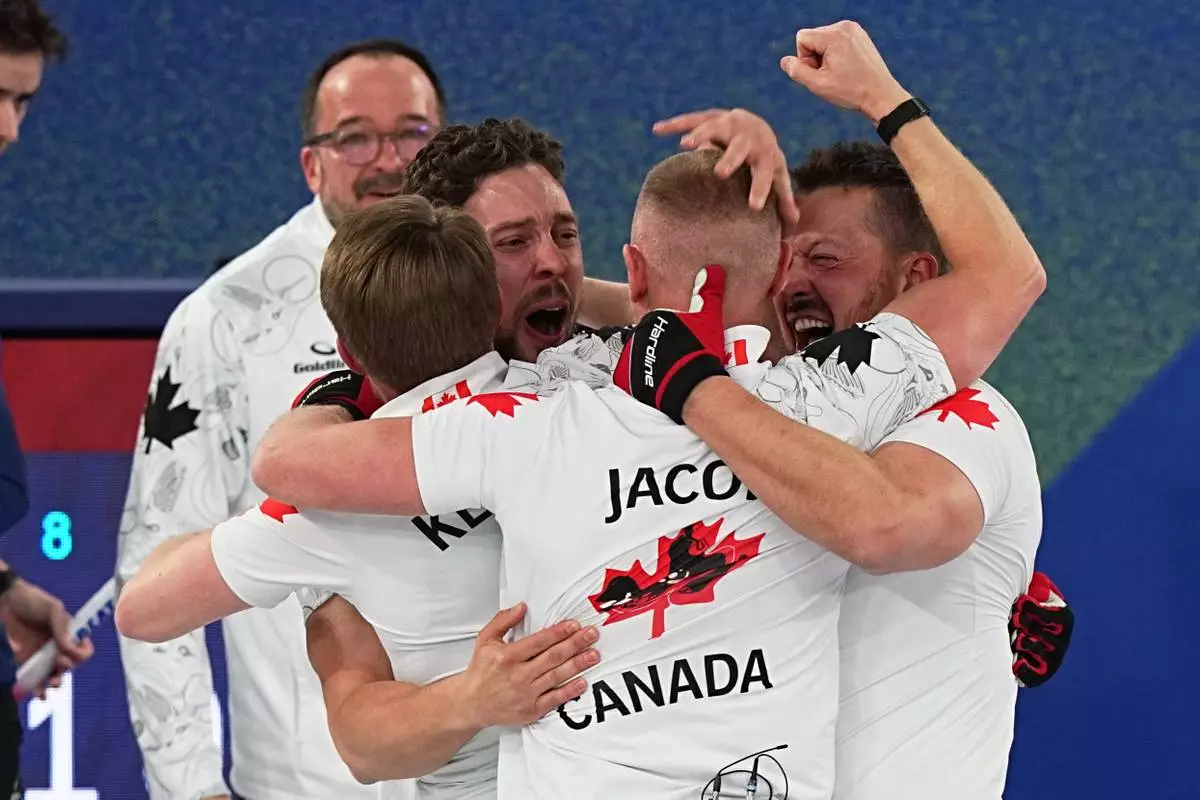 Canada's Brett Gallant, Brad Jacobs, Marc Kennedy and Ben Hebert celebrate defeating Britain in a men's curling gold medal match, at the 2026 Winter Olympics, in Cortina d'Ampezzo, Italy, Saturday, Feb. 21, 2026. (AP Photo/Fatima Shbair)