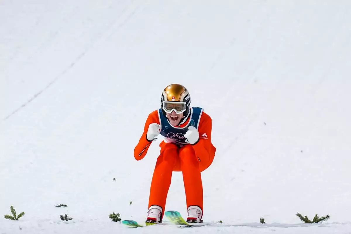 Gregor Deschwanden, of Switzerland, reacts after his first round jump of the ski jumping men's normal hill individual at the 2026 Winter Olympics, in Predazzo, Italy, Monday, Feb. 9, 2026. (AP Photo/Evgeniy Maloletka)