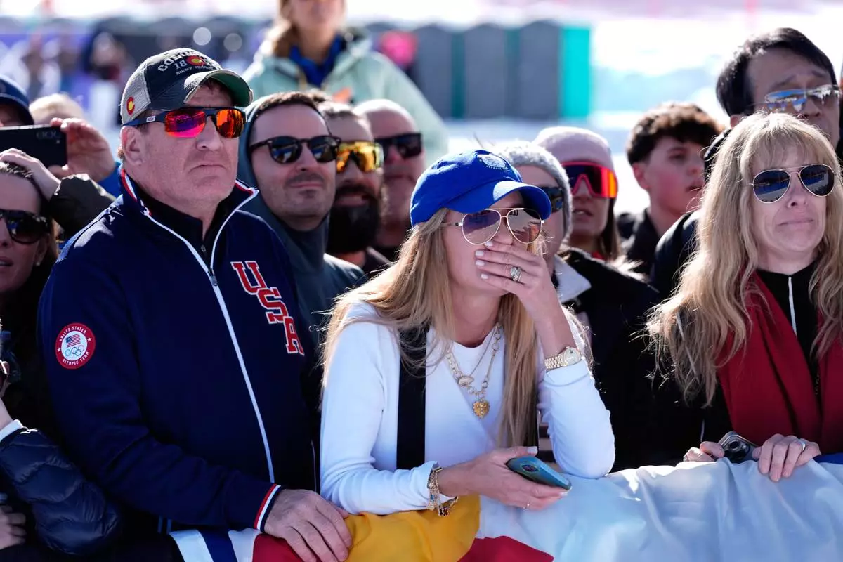 Spectators react after United States' Lindsey Vonn crashed during an alpine ski women's downhill race, at the 2026 Winter Olympics, in Cortina d'Ampezzo, Italy, Sunday, Feb. 8, 2026. (AP Photo/Robert F. Bukaty)