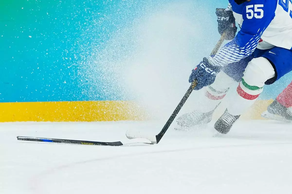 Italy's Luca Zanatta skates on ice during a men's ice hockey qualification playoff game between Switzerland and Italy at the 2026 Winter Olympics, in Milan, Italy, Tuesday, Feb. 17, 2026. (AP Photo/Petr David Josek)