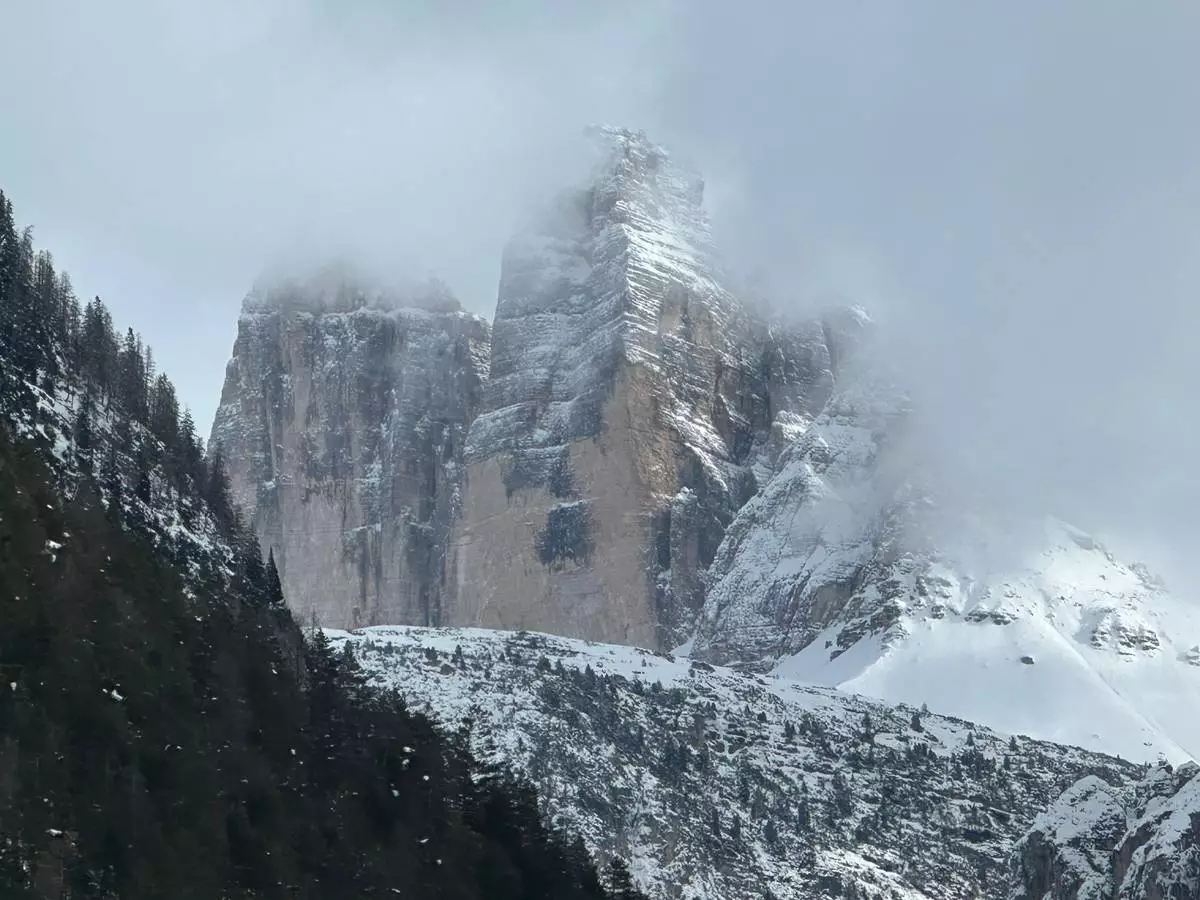 The Three Peaks of Lavaredo are visible from a panoramic viewing point in Brunico on Saturday, Feb. 7, 2026. The Cortina company Snowdreamers and Uber partnered to offer free snowmobiling tours on the weekends in February to the base of the peaks for people in town for the 2026 Winter Olympic Games. (AP Photo/ Jennifer McDermott)
