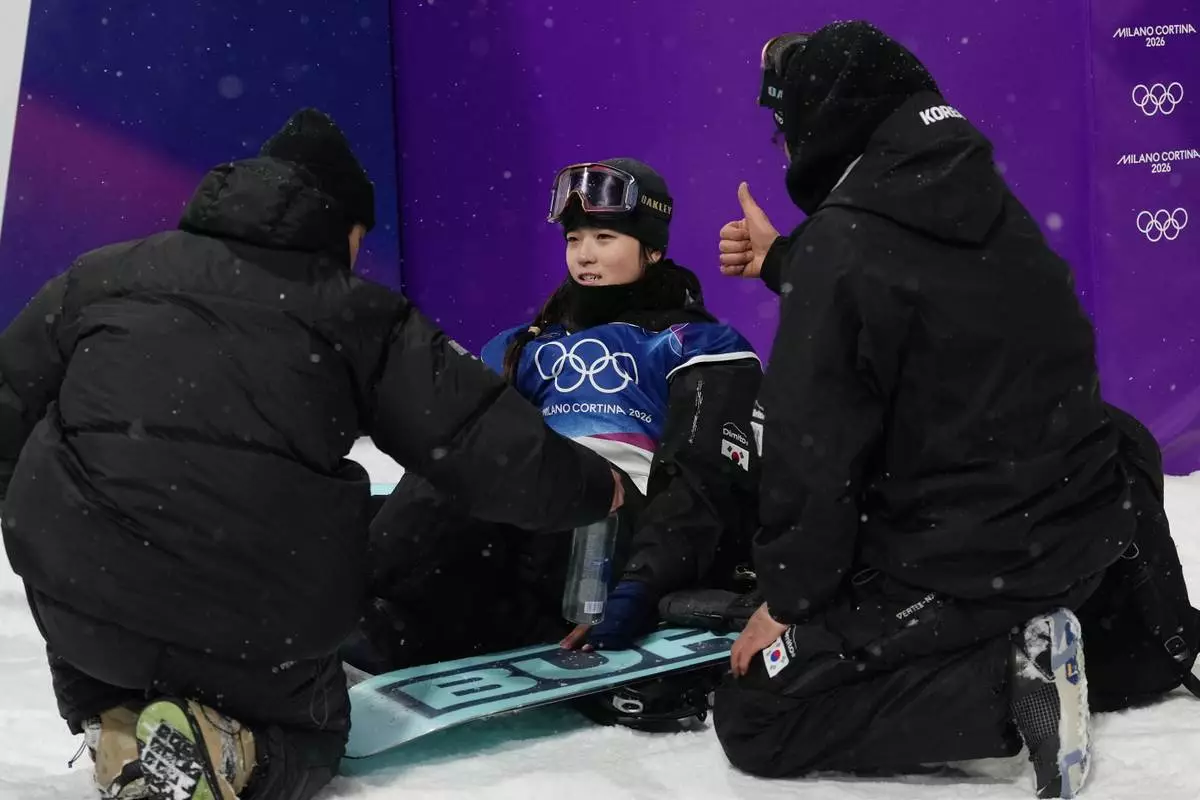 South Korea's Choi Ga-on celebrates with team members after her run during the women's snowboarding halfpipe finals at the 2026 Winter Olympics, in Livigno, Italy, Thursday, Feb. 12, 2026. (AP Photo/Lindsey Wasson)