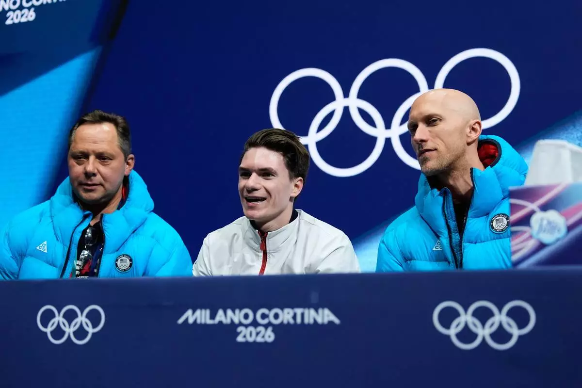 Maxim Naumov of the United States reacts to his scores after competing during the men's free skate program in figure skating at the 2026 Winter Olympics, in Milan, Italy, Friday, Feb. 13, 2026. (AP Photo/Francisco Seco)