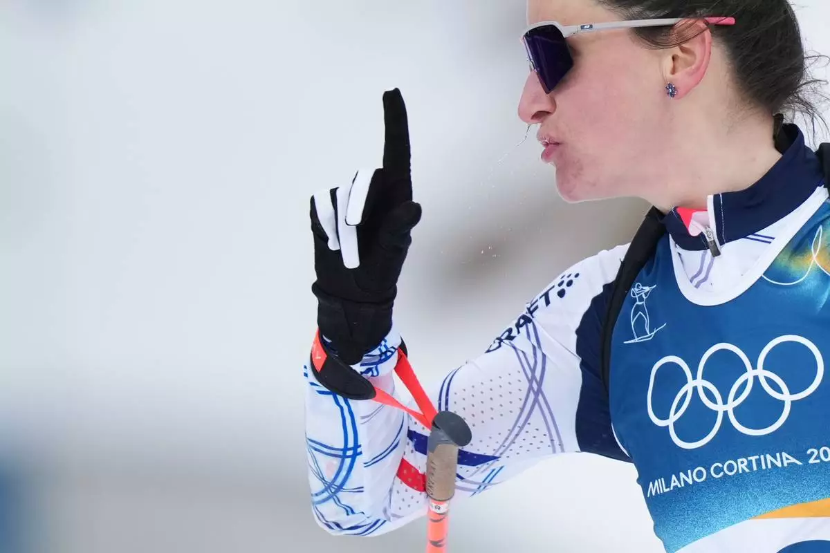 Julia Simon, of France, gestures after competing in the women's 15-kilometer individual biathlon race at the 2026 Winter Olympics in Anterselva, Italy, Wednesday, Feb. 11, 2026. (AP Photo/Andrew Medichini)