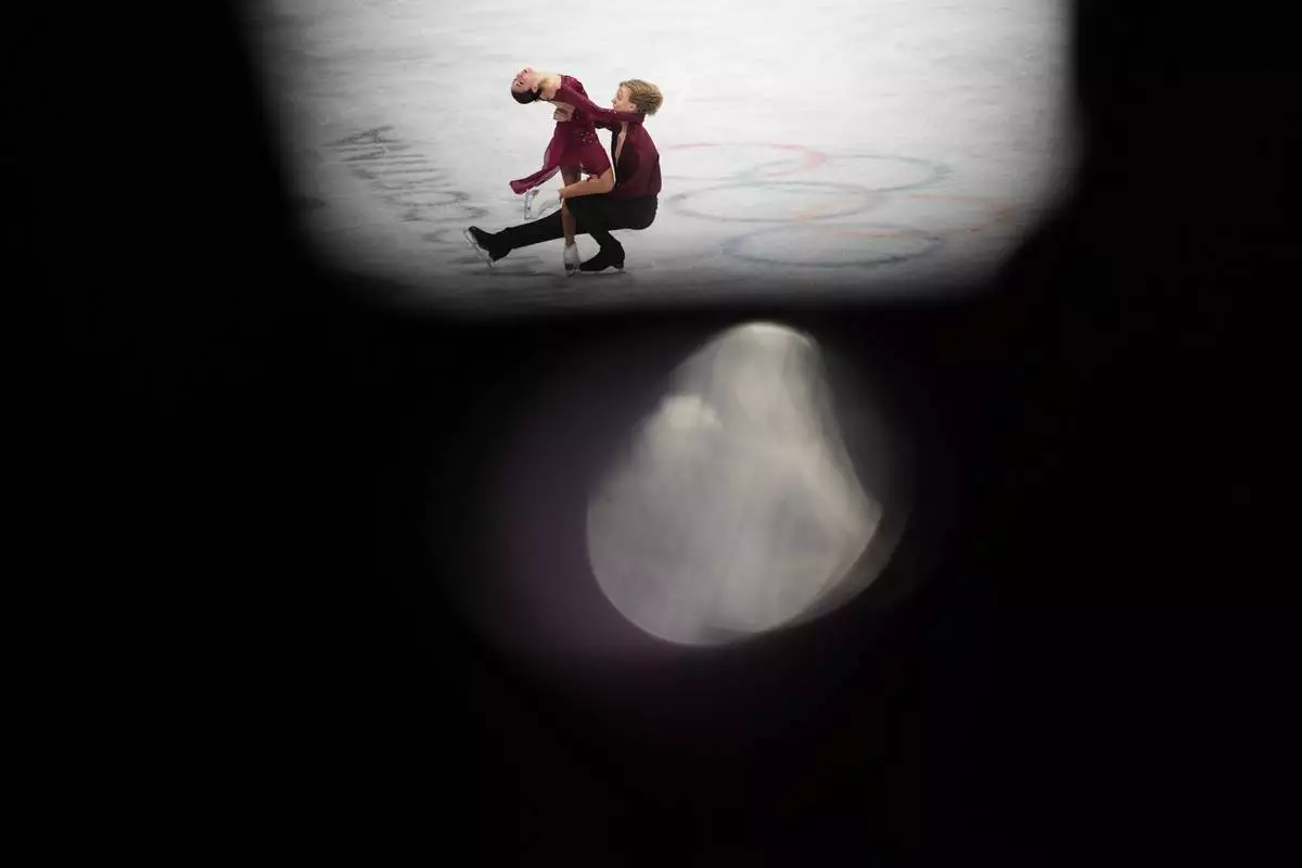 Diana Davis and Gleb Smolkin of Georgia compete during the ice dancing free skate in figure skating at the 2026 Winter Olympics, in Milan, Italy, Wednesday, Feb. 11, 2026. (AP Photo/Francisco Seco)