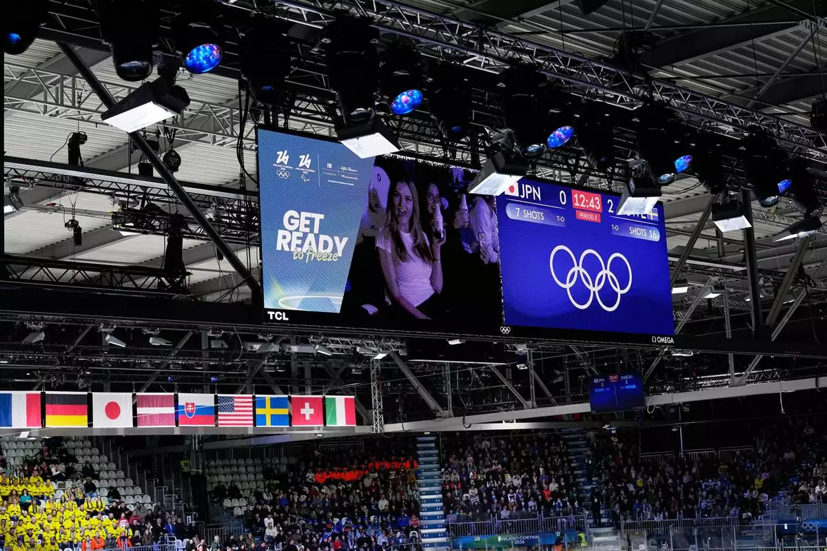 Fans are seen on a screen during an intermission of a preliminary round match of women's ice hockey between Japan and Sweden at the 2026 Winter Olympics, in Milan, Italy, Tuesday, Feb. 10, 2026. (AP Photo/Petr David Josek)