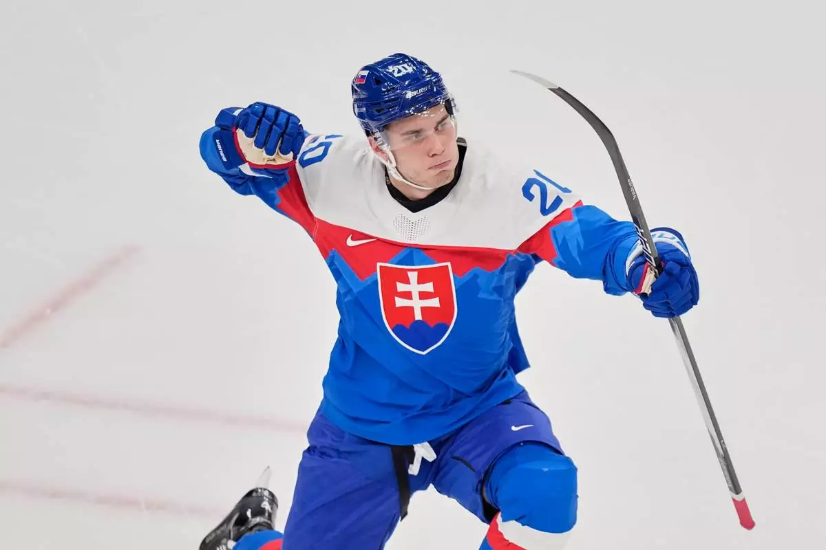Slovakia's Juraj Slafkovsky celebrates after scoring her side's opening goal during a preliminary round match of men's ice hockey between Slovakia and Finland at the 2026 Winter Olympics, in Milan, Italy, Wednesday, Feb. 11, 2026. (AP Photo/Petr David Josek)