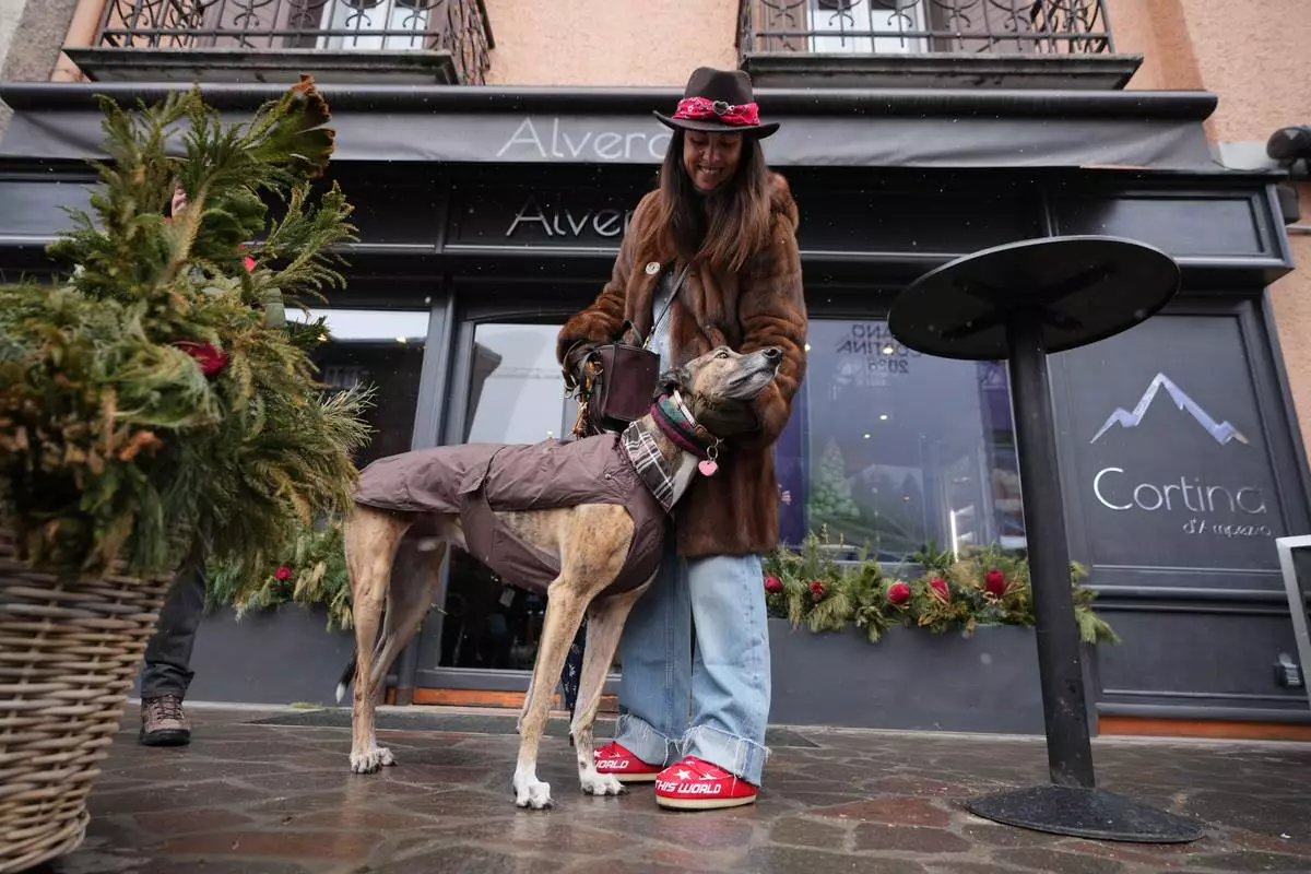 Cecilia Secondin poses with her dog Porter in Cortina d'Ampezzo, Italy, Saturday, Feb. 14, 2026. (AP Photo/Alessandra Tarantino)