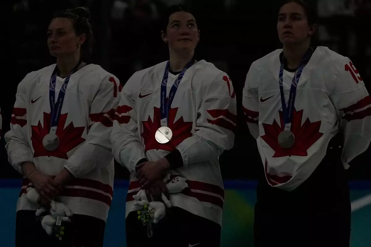 The silver medal on Canada's Ella Shelton reflects during medals ceremony at the 2026 Winter Olympics, in Milan, Italy, Thursday, Feb. 19, 2026. (AP Photo/Hassan Ammar)