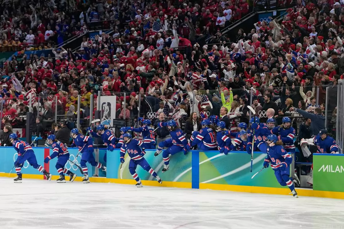 United States players celebrate after a women's ice hockey gold medal game between the United States and Canada at the 2026 Winter Olympics, in Milan, Italy, Thursday, Feb. 19, 2026. (AP Photo/Hassan Ammar)