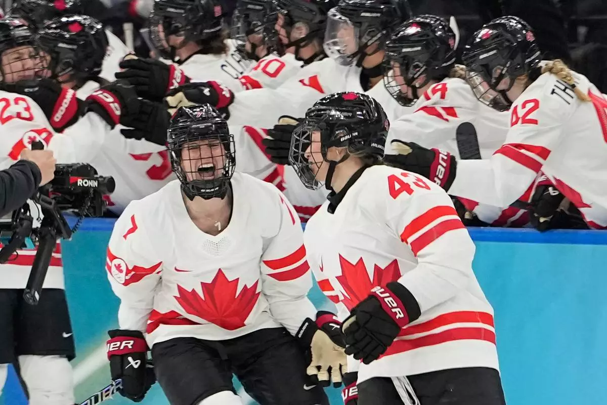 Canada's Kristin O'Neill (43) celebrates after scoring her side's opening goal during a women's ice hockey gold medal game between the United States and Canada at the 2026 Winter Olympics, in Milan, Italy, Thursday, Feb. 19, 2026. (AP Photo/Hassan Ammar)