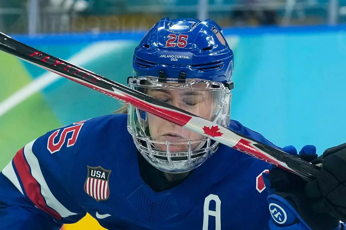 United States' Alex Carpenter (25) and Canada's Claire Thompson (42) challenge for the puck during a women's ice hockey gold medal game between the United States and Canada at the 2026 Winter Olympics, in Milan, Italy, Thursday, Feb. 19, 2026. (AP Photo/Petr David Josek)