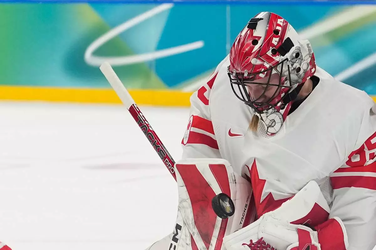 Canada's Ann-Renee Desbiens (35) makes a save during a women's ice hockey gold medal game between the United States and Canada at the 2026 Winter Olympics, in Milan, Italy, Thursday, Feb. 19, 2026. (AP Photo/Hassan Ammar)