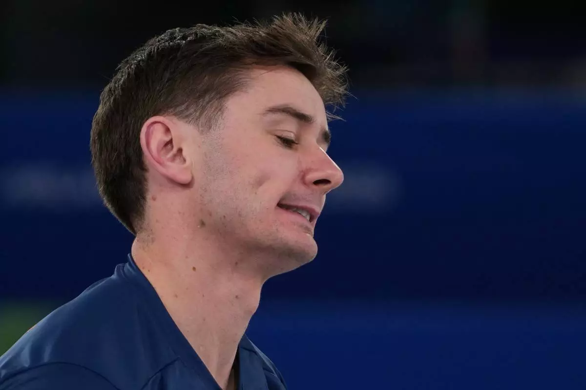 Britain's Grant Hardie reacts during a men's curling gold medal match between Britain and Canada, at the 2026 Winter Olympics, in Cortina d'Ampezzo, Italy, Saturday, Feb. 21, 2026. (AP Photo/Misper Apawu)