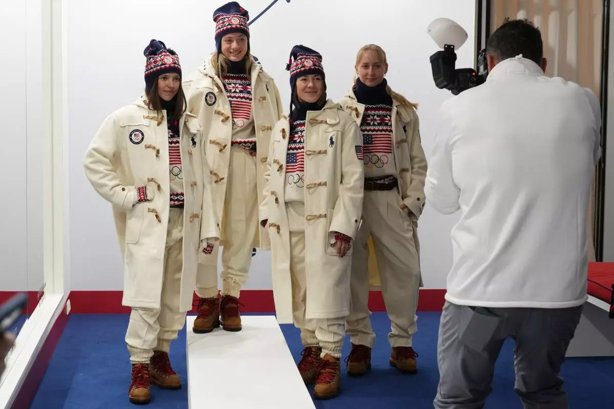 From left, United States' Tess Johnson, Olivia Giaccio, Jaelin Kauf and Elizabeth Lemley pose for a photographer as they wear the Team USA uniforms designed by Ralph Lauren, at the 2026 Winter Olympics, in Milan, Italy, Wednesday, Feb. 4, 2026. (AP Photo/Antonio Calanni)
