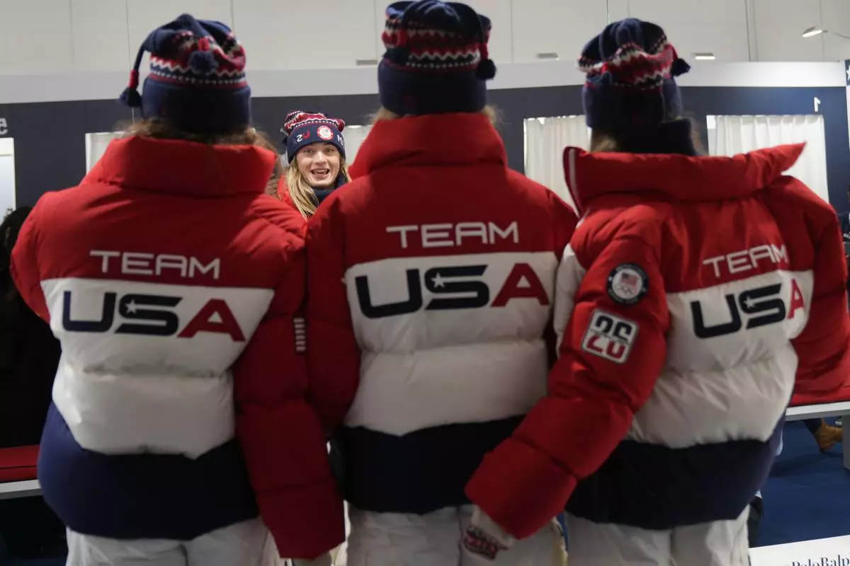 United States' Olivia Giaccio speaks with her teammates as they wear the Team USA uniforms designed by Ralph Lauren, at the 2026 Winter Olympics, in Milan, Italy, Wednesday, Feb. 4, 2026. (AP Photo/Antonio Calanni)