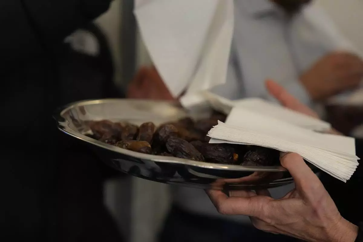 Dates are arranged on silver plates before the breaking of the fast at the Al-Wahid mosque during Ramadan in Milan, Italy, Friday, Feb. 20, 2026. (AP Photo/María Teresa Hernández)