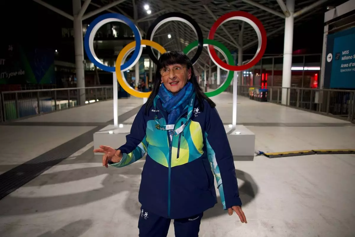 Angela Frisina, a volunteer at the 2026 Winter Olympics walks through the venue that hosts the women’s ice hockey, in Milan, Italy, Monday, Feb. 9, 2026. (AP Photo/Vasilisa Stepanenko)
