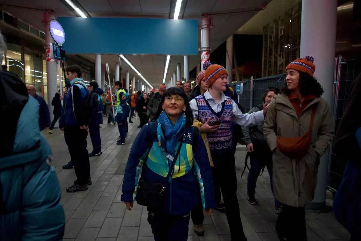 Angela Frisina, a volunteer at the 2026 Winter Olympics walks through the venue that hosts the women’s ice hockey, in Milan, Italy, Monday, Feb. 9, 2026. (AP Photo/Vasilisa Stepanenko)