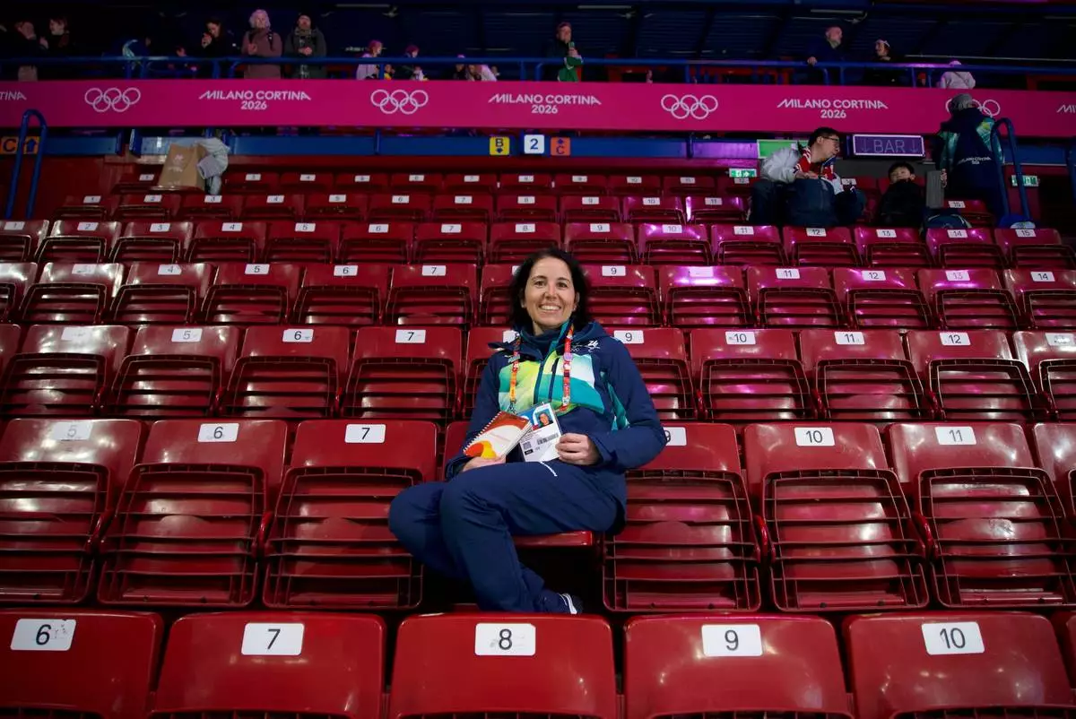 Cristina Romagnoli, a volunteer poses at the venue that hosts the short track speedskating, at the 2026 Winter Olympics, in Milan, Italy, Sunday, Feb. 8, 2026. (AP Photo/Vasilisa Stepanenko