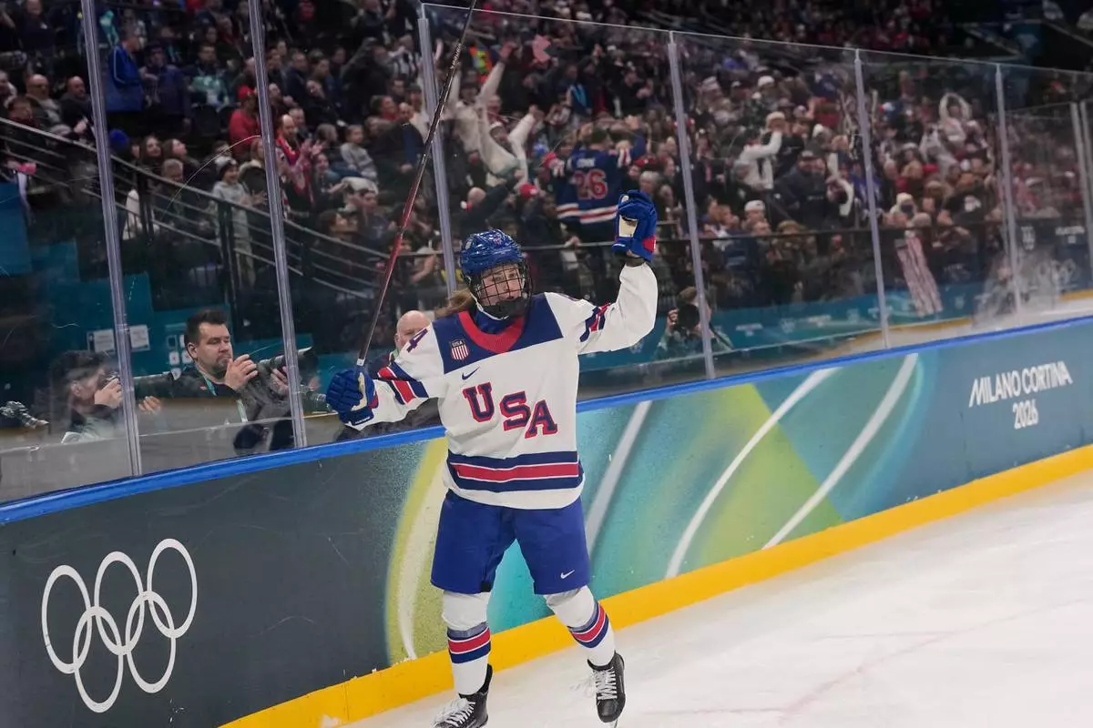 United States' Caroline Harvey celebrates after scoring her side's first goal during a preliminary round match of women's ice hockey between USA and Canada at the 2026 Winter Olympics, in Milan, Italy, Tuesday, Feb. 10, 2026. (AP Photo/Petr David Josek)