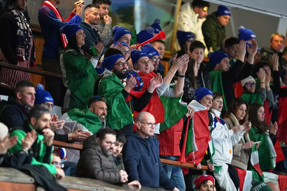 Italy fans watch the men's curling round robin session against Britain, at the 2026 Winter Olympics, in Cortina d'Ampezzo, Italy, Friday, Feb. 13, 2026. (AP Photo/Fatima Shbair)