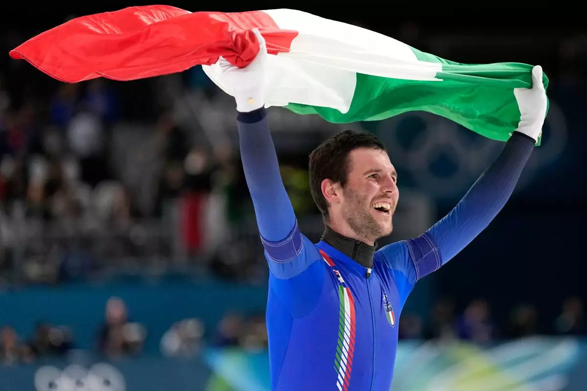 Team Italy's Michele Malfatti celebrates winning the gold medal in the final of the men's team pursuit speedskating race at the 2026 Winter Olympics, in Milan, Italy, Tuesday, Feb. 17, 2026. (AP Photo/Ben Curtis)