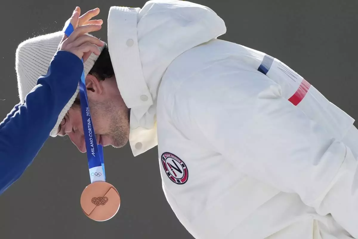 Sturla Holm Laegreid, of Norway, gets the bronze medal for the men's 10-kilometer sprint biathlon race at the 2026 Winter Olympics in Anterselva, Italy, Friday, Feb. 13, 2026. (AP Photo/Andrew Medichini)