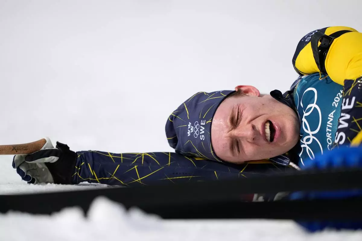 Sebastian Samuelsson, of Sweden, reacts in the finish area of the men's 10-kilometer sprint biathlon race at the 2026 Winter Olympics in Anterselva, Italy, Friday, Feb. 13, 2026. (AP Photo/Mosa'ab Elshamy)