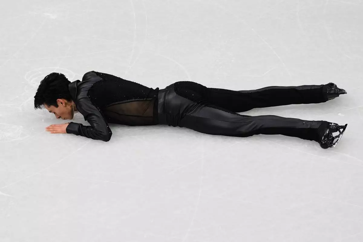 Donovan Carrillo of Mexico kisses the ice after competing during the men's free skate program in figure skating at the 2026 Winter Olympics, in Milan, Italy, Friday, Feb. 13, 2026. (AP Photo/Francisco Seco)