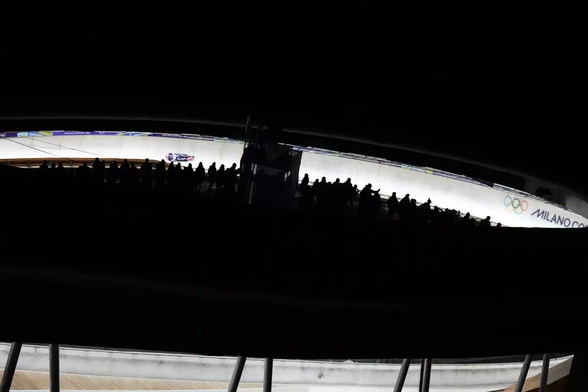 Czech Republic's Anna Fernstaedt slides down the track during a women's skeleton run at the 2026 Winter Olympics, in Cortina d'Ampezzo, Italy, Friday, Feb. 13, 2026. (AP Photo/Aijaz Rahi)