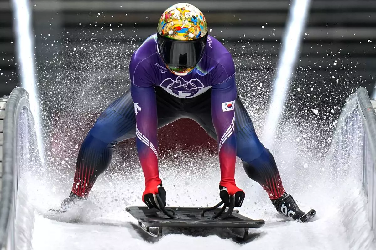 South Korea's Jisoo Kim arrives at the finish during a men's skeleton run at the 2026 Winter Olympics, in Cortina d'Ampezzo, Italy, Friday, Feb. 13, 2026. (AP Photo/Aijaz Rahi)