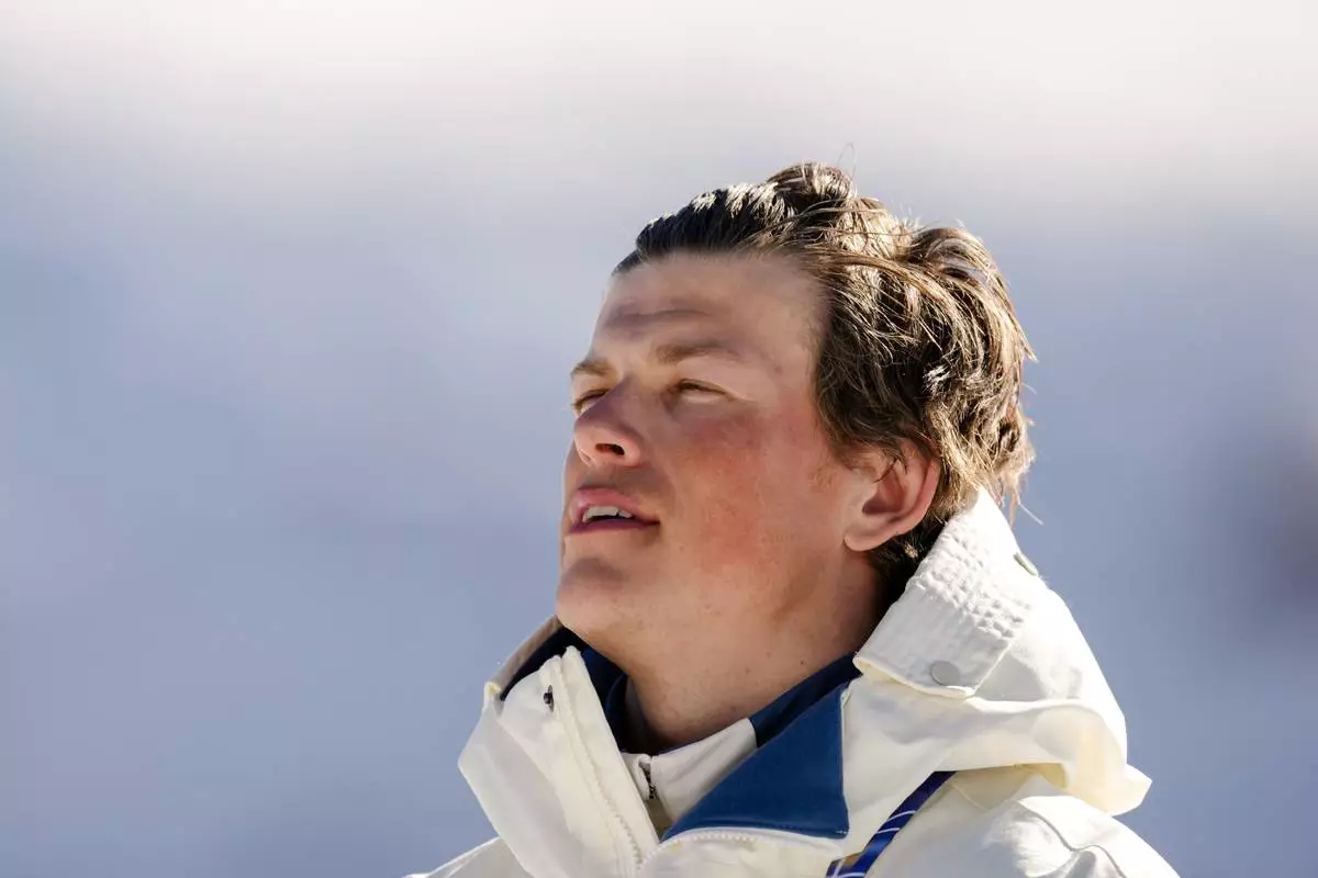 Johannes Hoesflot Klaebo, of Norway, stands on the podium after winning the gold medal in the cross country skiing men's 10km interval start free at the 2026 Winter Olympics, in Tesero, Italy, Friday, Feb. 13, 2026. (AP Photo/Evgeniy Maloletka)