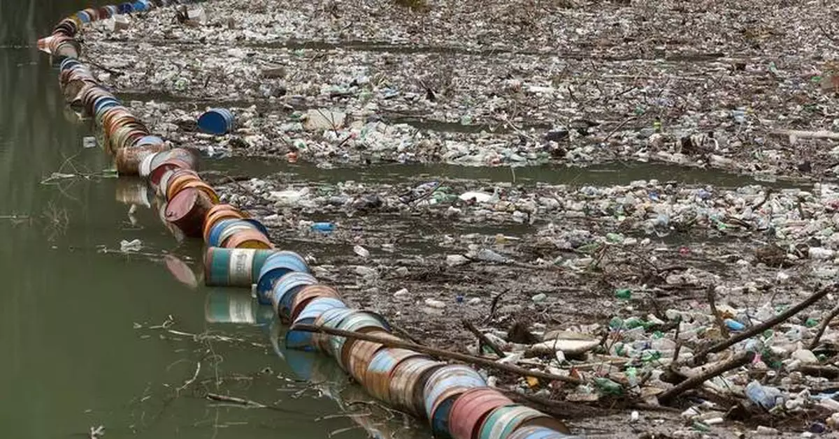 Photos show workers clearing waves of trash from Bosnia’s Drina River