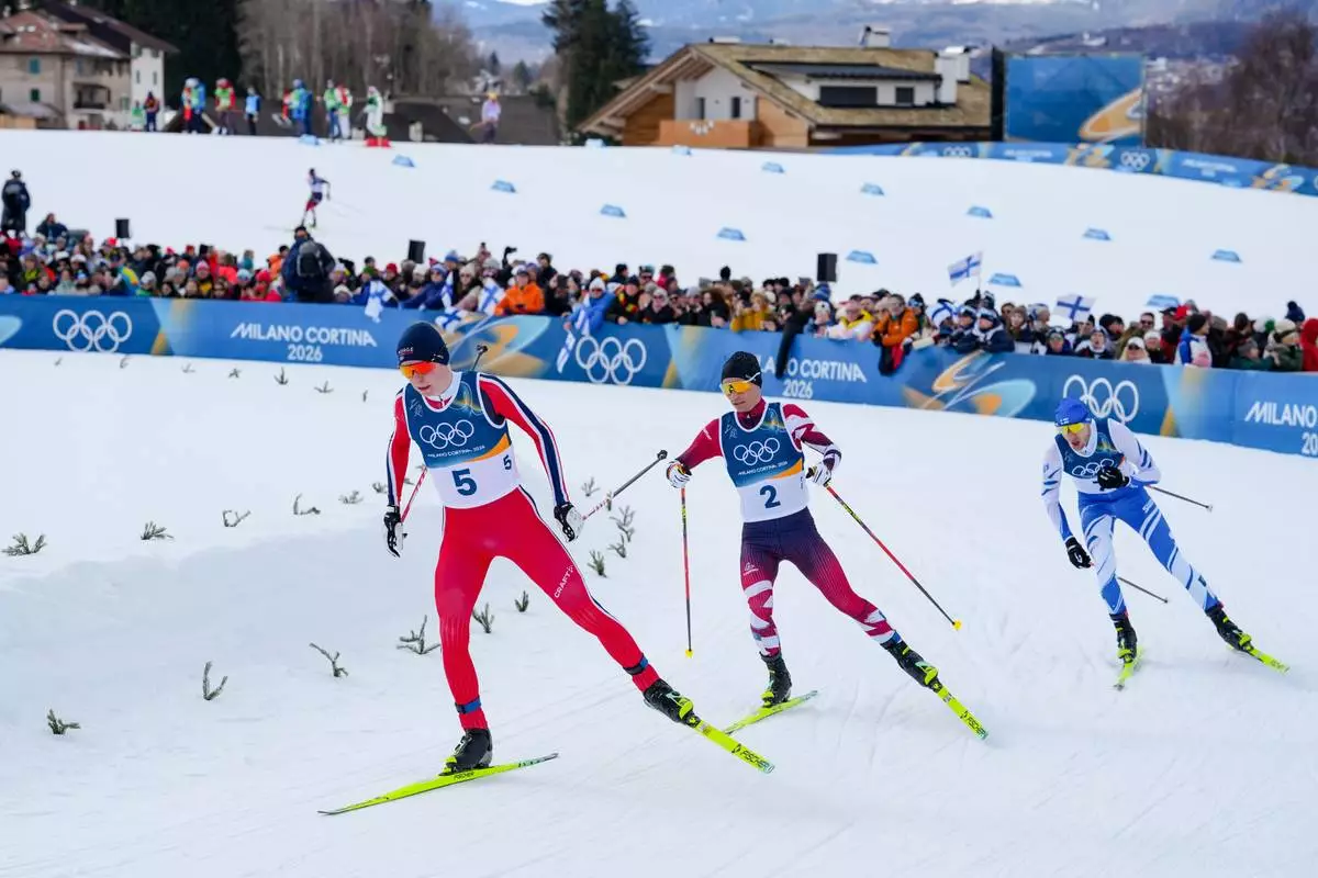 Jens Luraas Oftebro, of Norway, from left, Johannes Lamparter, of Austria, and Ilkka Herola, of Finland, compete in the nordic combined individual Gundersen large hill/10km at the 2026 Winter Olympics, in Tesero, Italy, Tuesday, Feb. 17, 2026. (AP Photo/Evgeniy Maloletka)