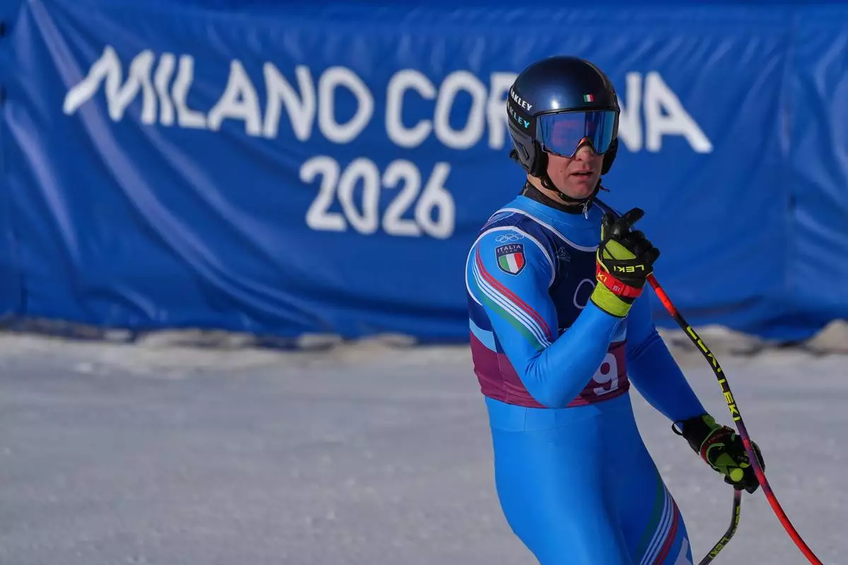 Italy's Giovanni Franzoni celebrates at the finish area of an alpine ski men's downhill portion of a team combined race, at the 2026 Winter Olympics, in Bormio, Italy, Monday, Feb. 9, 2026. (AP Photo/Rebecca Blackwell)