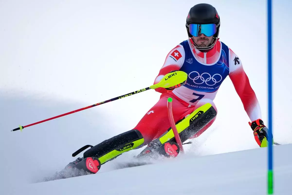Switzerland's Tanguy Nef speeds down the course of an alpine ski men's slalom portion of a team combined race, at the 2026 Winter Olympics, in Bormio, Italy, Monday, Feb. 9, 2026. (AP Photo/John Locher)