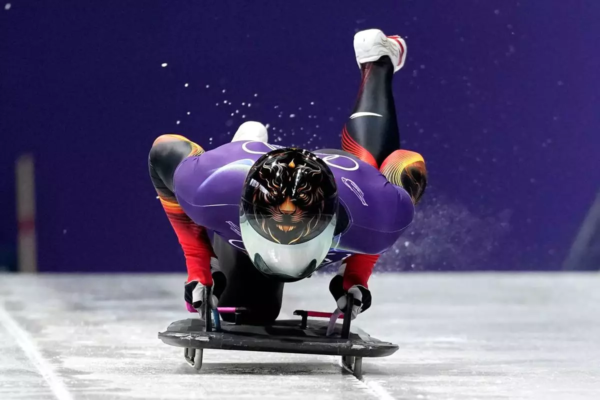 China's Lin Qinwei starts for a men's skeleton training session at the 2026 Winter Olympics, in Cortina d'Ampezzo, Italy, Monday, Feb. 9, 2026. (AP Photo/Alessandra Tarantino)