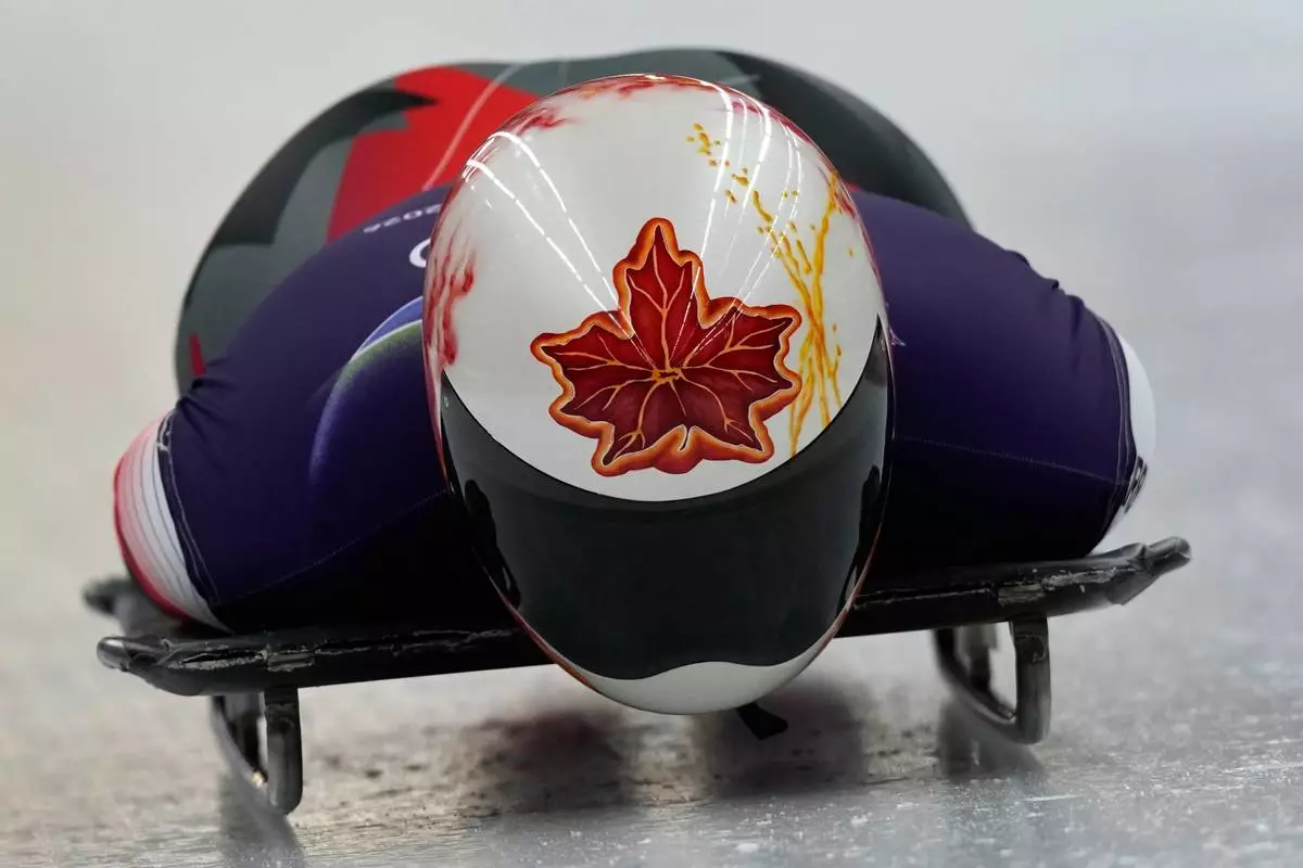 Canada's Hallie Clarke starts for a women's skeleton training session at the 2026 Winter Olympics, in Cortina d'Ampezzo, Italy, Tuesday, Feb. 10, 2026. (AP Photo/Aijaz Rahi)