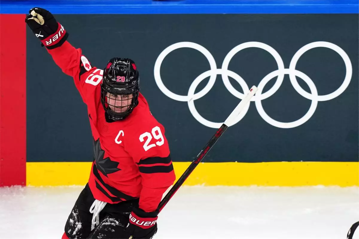 Canada's Marie-Philip Poulin celebrates after scoring her second goal of the game during the second period of a women's ice hockey semifinal match against Switzerland at the 2026 Winter Olympics, in Milan, Italy, Monday, Feb. 16, 2026. (AP Photo/Carolyn Kaster)