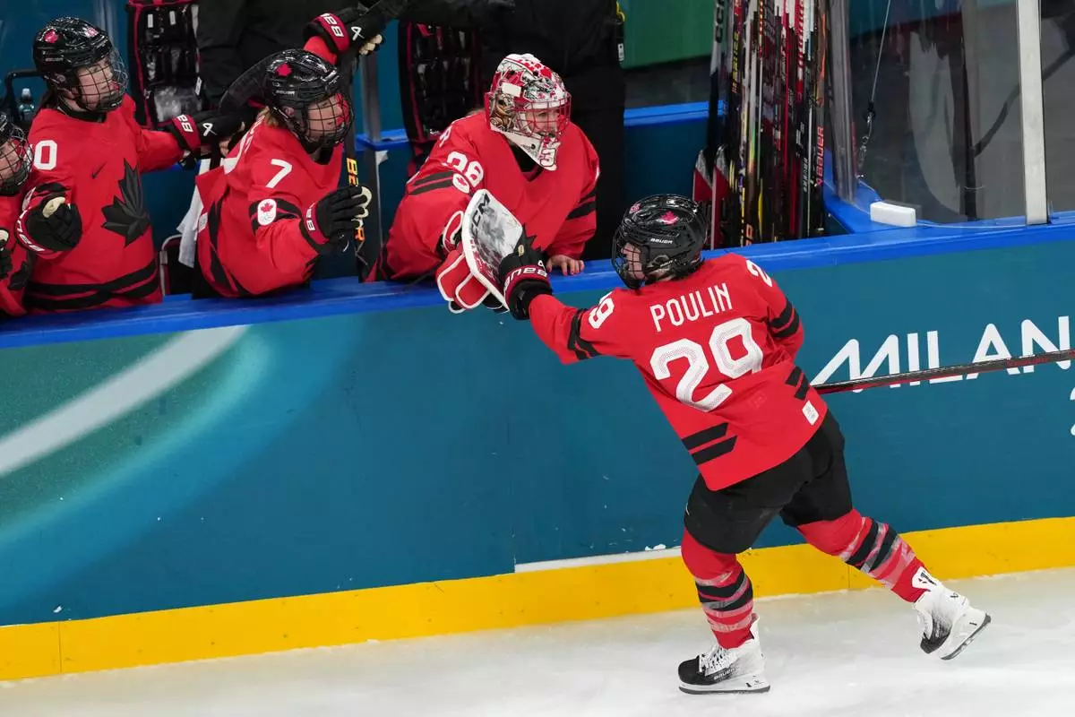 Canada's Marie-Philip Poulin (29) celebrates after scoring her first goal of the game against Switzerland during the second period of a women's ice hockey semifinal match at the 2026 Winter Olympics, in Milan, Italy, Monday, Feb. 16, 2026. (AP Photo/Carolyn Kaster)
