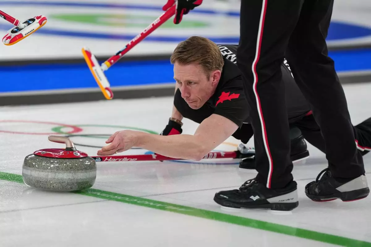 Canada's Marc Kennedy in action during the men's curling round robin session against Sweden, at the 2026 Winter Olympics, in Cortina d'Ampezzo, Italy, Friday, Feb. 13, 2026. (AP Photo/Misper Apawu)