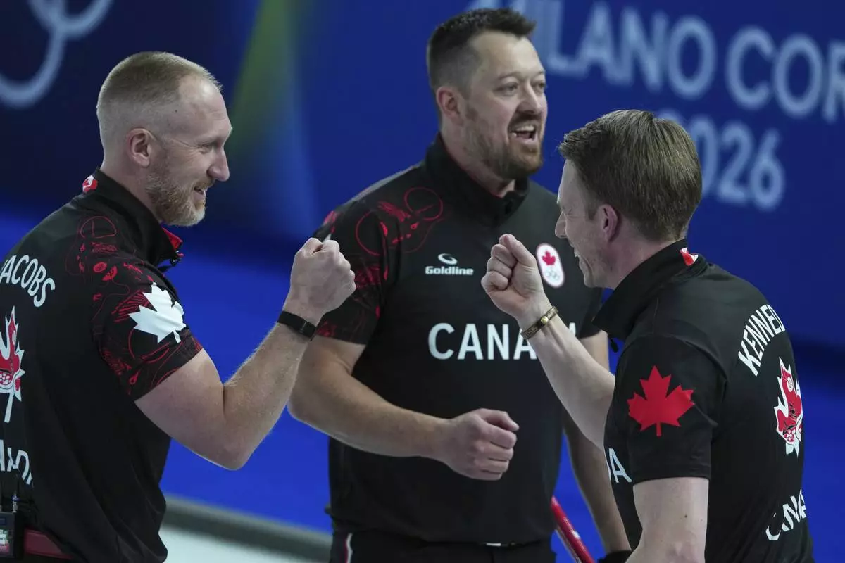 Canada's Marc Kennedy, Brad Jacobs, and Ben Hebert react after the men's curling round robin session against Sweden, at the 2026 Winter Olympics, in Cortina d'Ampezzo, Italy, Friday, Feb. 13, 2026. (AP Photo/Misper Apawu)
